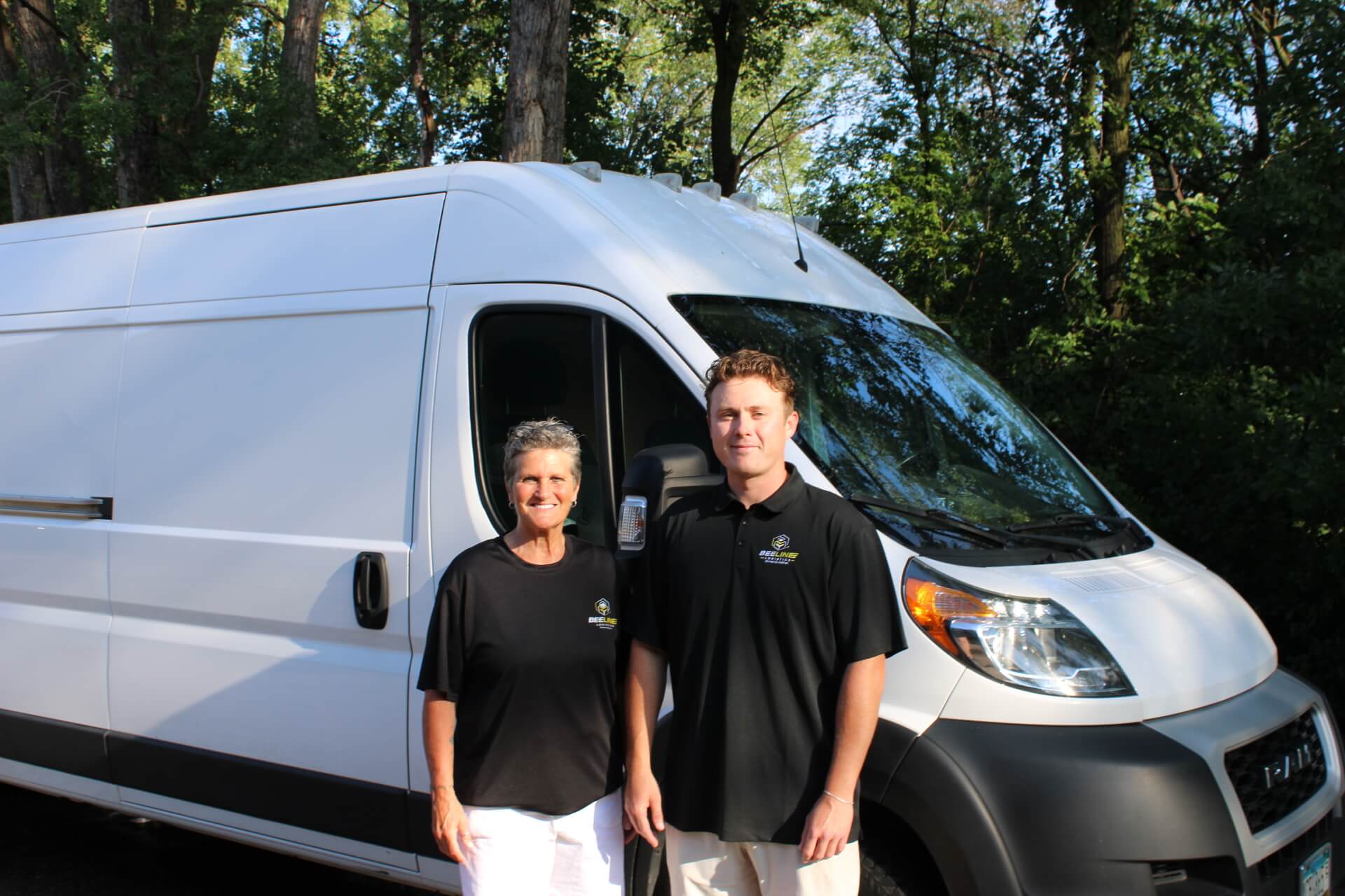 Stacie Ott and Dylan Ott, Co-Owners of Beeline Logistics, standing in front of a Beeline High-Top Sprinter van in Minnesota